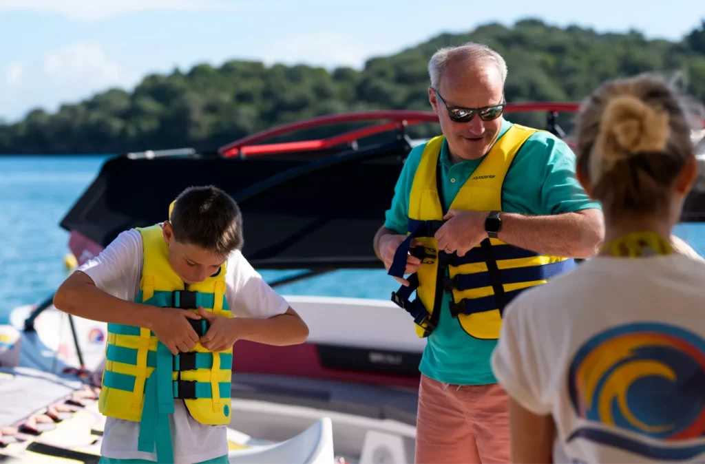 corfu ski club dad with son wearing vests